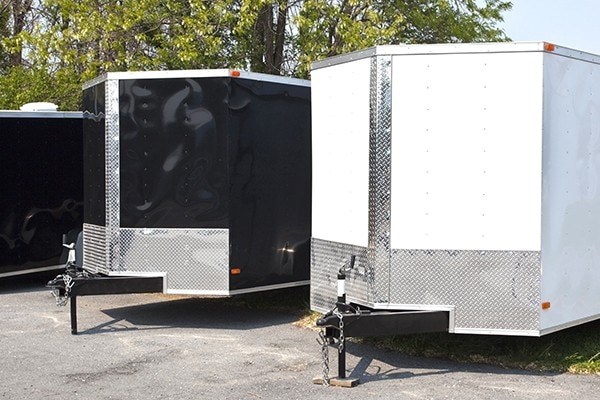 Three black and white transport trailers for sale or rent in a row.; Shutterstock ID 629358170; purchase_order: Fleet - Web; job: ; client: ; other: 