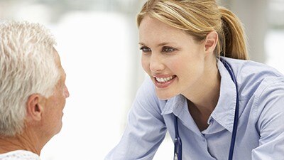 Senior patient talking with young doctor